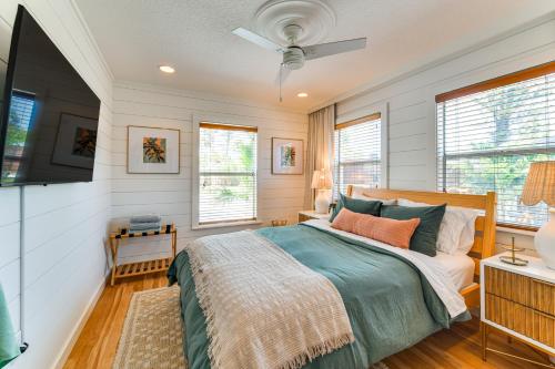 a bedroom with a bed and a flat screen tv at Walk to Gulf Luxe Luau-Themed Gem in Holmes Beach in Holmes Beach