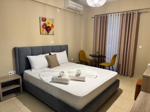 a bedroom with a bed with towels on it at Hotel Driloni in Ksamil