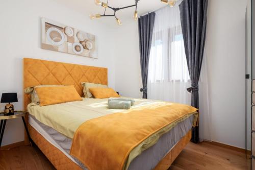 a bedroom with a large bed with a yellow blanket at Mirela's golden luxury apartment in Split