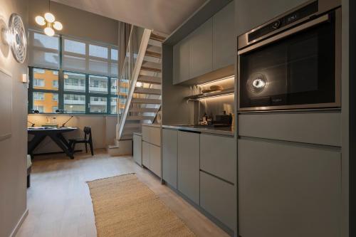 a kitchen with a microwave oven and a sink at Unity Hammarby Sjöstad - A Studio Hotel in Stockholm