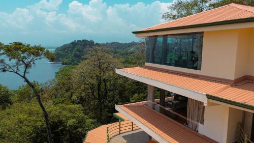 a balcony of a house with a view of the water at Issimo Suites (Adults Only) in Manuel Antonio