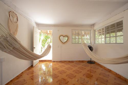 a room with hammocks and a heart on the wall at Cenote Popol Vuh in Leona Vicario