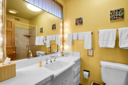 a bathroom with a large sink and a mirror at Coyote Inn - 21 and Over in Palm Springs