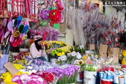 a woman talking on a cell phone in a flower shop at Rose Apartment Kea Farm in Cameron Highlands