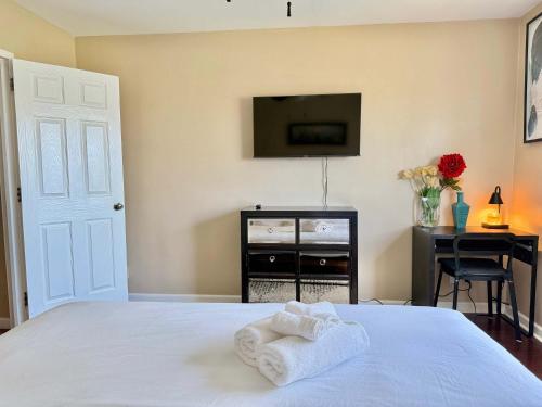a bedroom with a bed with a tv and a desk at ATL Downtown City View Onsite Parking LM802 in Atlanta