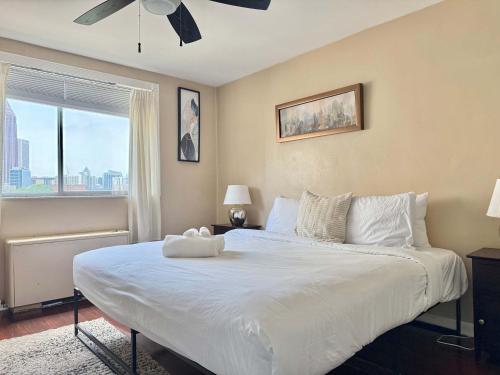 a bedroom with a large white bed with a window at ATL Downtown City View Onsite Parking LM802 in Atlanta