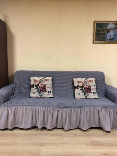 a bed in a room with two pillows on it at Sunny in Tqibuli
