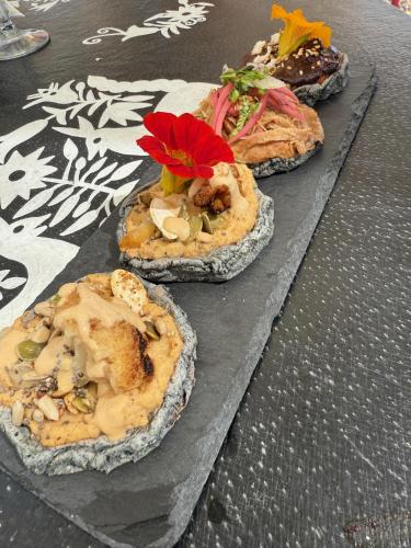 a group of three pizzas sitting on a table at Casa Pavo Real en el Viñedo El Pavo Real del Campo in San Miguel de Allende