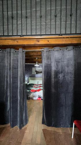 a bedroom with black curtains and a bed in a room at Il Rustico in Pozzillo
