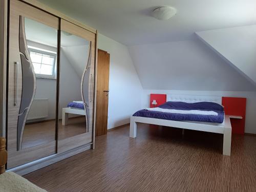 a bedroom with a bed and a large mirror at Villa Sienna in Smrdan