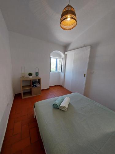 a bedroom with a bed with a towel on it at Blue Dragon River House in Odeleite