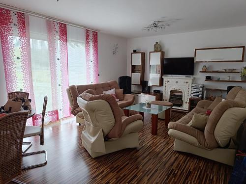 a living room with chairs and a fire place at Villa Sienna in Smrdan