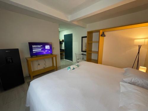 Una cama o camas en una habitación de Casona Suites
