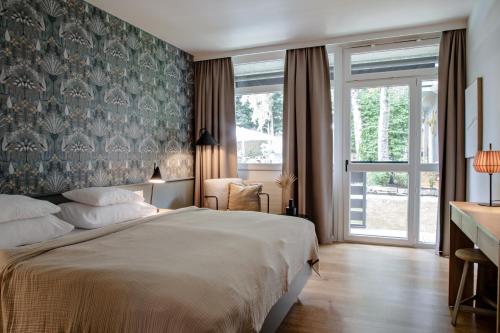 a bedroom with a large bed and a window at Das Esel - Kleinod in Rust in Rust