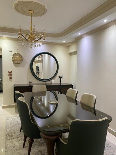 a dressing table with chairs and a mirror on the wall at Villa In 5th Settlement in Cairo