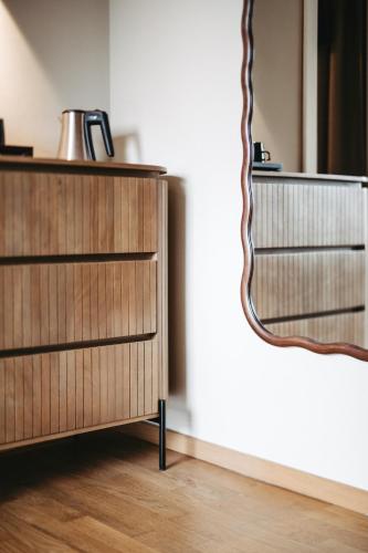 a wooden dresser in a room with a mirror at Das Esel - Kleinod in Rust in Rust