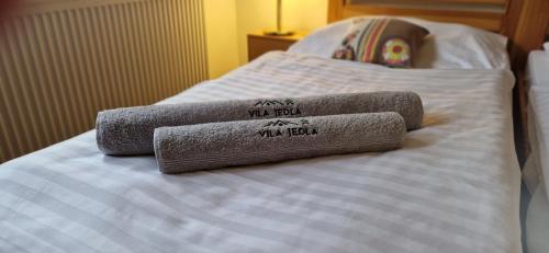 two towels sitting on top of a bed at Vila Jedľa in Smokovce