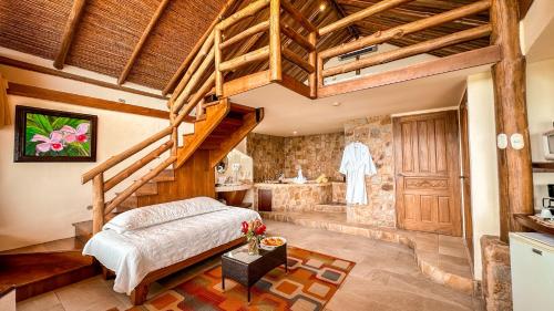 a bedroom with a bed and a staircase and a sink at Issimo Suites (Adults Only) in Manuel Antonio