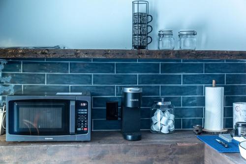 a microwave oven sitting on a counter next to a wall at Cozy Cabin Gateway with Pool and Firepit in Montgomery