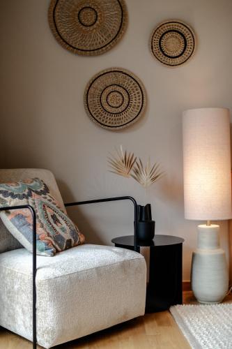 a living room with a couch and a lamp at Das Esel - Kleinod in Rust in Rust