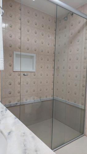 a shower with a glass door in a bathroom at Happy Hotel Garvey Park in Brasília