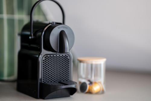 a black appliance sitting on a counter with a candle at Apfelland Hideaways mit Sauna in Puch bei Weiz