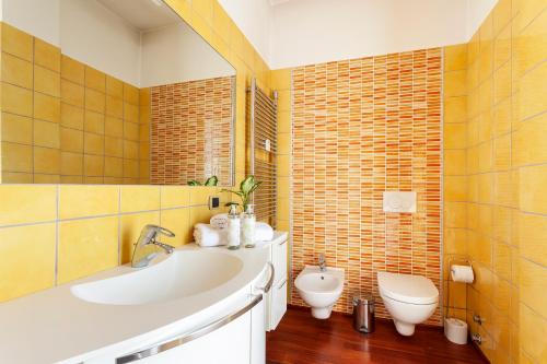 a bathroom with a sink and a toilet at the red penthouse - family apart with terrace 2 bedroom private park in Sesto Calende