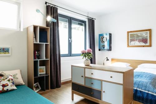 a bedroom with a bed and a desk and a window at Das Esel - Kleinod in Rust in Rust