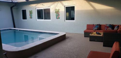 a large swimming pool in a living room at Private Bedroom with Bath & Pool Access in Peaceful Port Saint Lucie in Port Saint Lucie