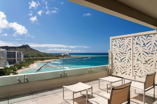 a balcony with chairs and a view of the ocean at Moana Surfrider, A Westin Resort & Spa, Waikiki Beach in Honolulu