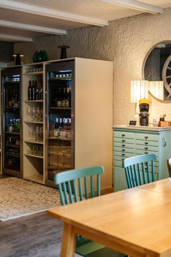 a dining room with a table and blue chairs at Das Esel - Kleinod in Rust in Rust
