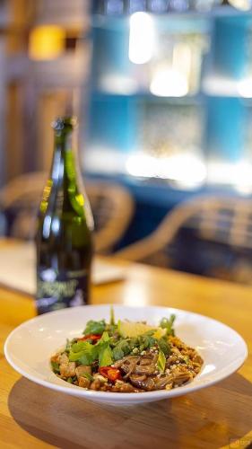 a plate of food on a table with a bottle at Pensjonat Retro in Łomża