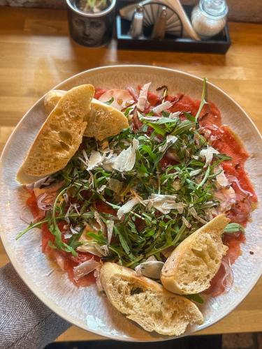 a plate of food with a pizza on a table at Pensjonat Retro in Łomża