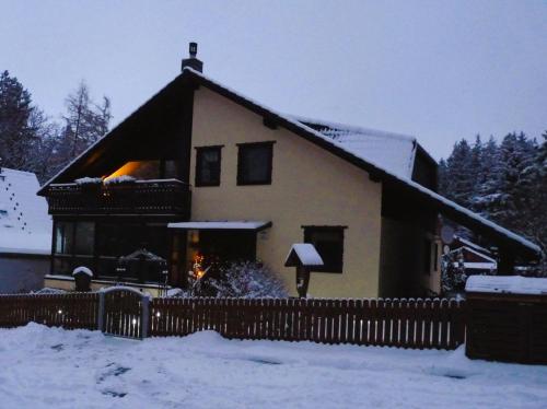 a house in the snow with a fence at Gemütliches Appartement In Ottenhai Mit Grill in Bad Harzburg