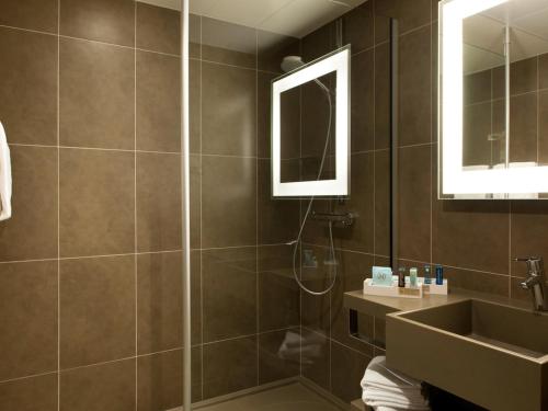 a bathroom with a shower and a sink at Novotel Paris Nord Expo Aulnay in Aulnay-sous-Bois