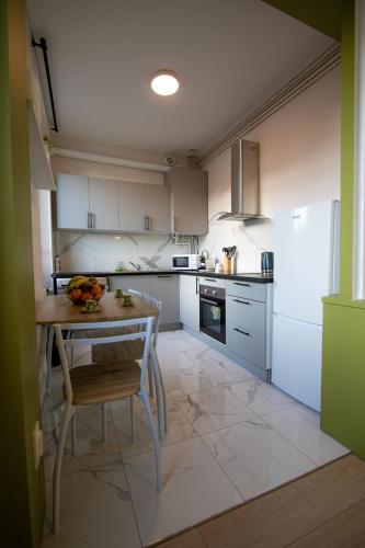 une cuisine avec une table avec un bol de fruits dessus dans l'établissement La Strada, à Montargis