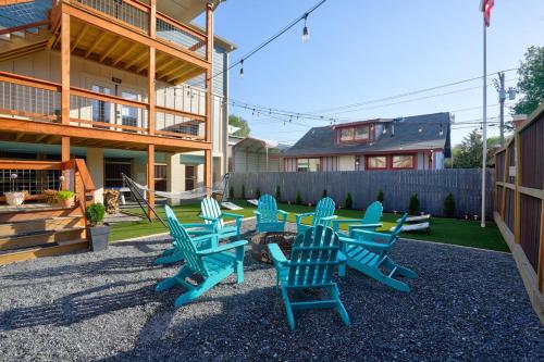 a group of blue lawn chairs in a yard at Charming Downtown Bryson City SkyLoft Studio 3 - Perfect for Couples in Bryson City