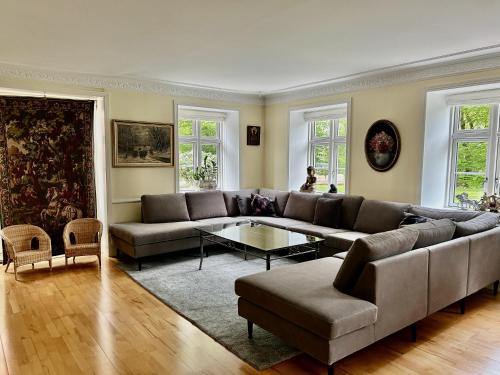 a living room with a couch and a table at 300m2 entire house with 3 bedrooms in Tistrup