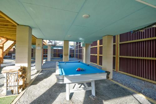 a pool table on the outside of a building at Charming Downtown Bryson City SkyLoft Studio 4 - Perfect for Couples in Bryson City