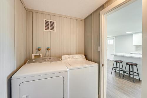 a laundry room with a white washer and dryer at Less Than 3 Mi to Double JJ Resort Home with Large Yard! in Rothbury