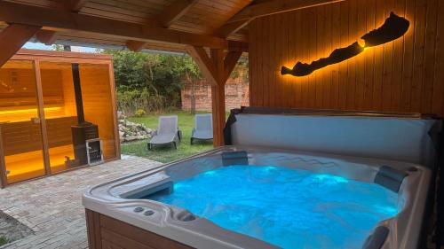 a large hot tub in a backyard with a patio at Balaton Apartman in Balatonmáriafürdő