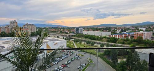 a city with cars parked in a parking lot at Planet Residence NiNa in Niš