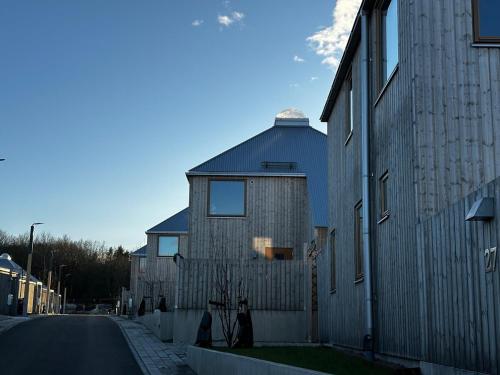 a large building with a fence next to a street at Kivikshusen in Kivik