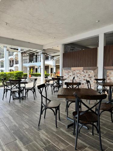a group of tables and chairs in a restaurant at Hotel Mercy in San Juan La Laguna