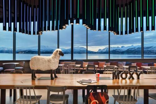 a sheep standing on a table in a restaurant at Moxy Tromso in Tromsø