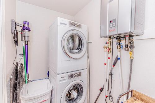 a laundry room with a washing machine and a washer at Experience tranquility at The Bird's Nest in Bryson City