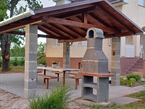 a picnic shelter with a table and a stove at HutiFeri apartman in Siófok