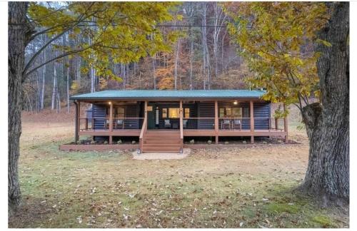 a large house in the middle of a forest at Experience tranquility at The Bird's Nest in Bryson City