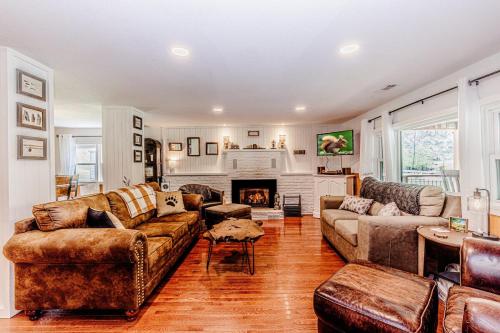 a living room with leather furniture and a fireplace at Experience tranquility at The Bird's Nest in Bryson City