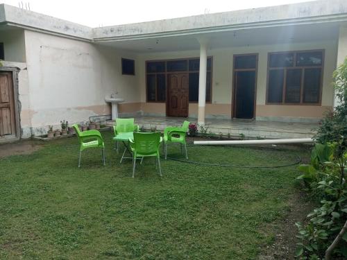 a table and chairs in the yard of a house at WindyCrest Inn in Chitral